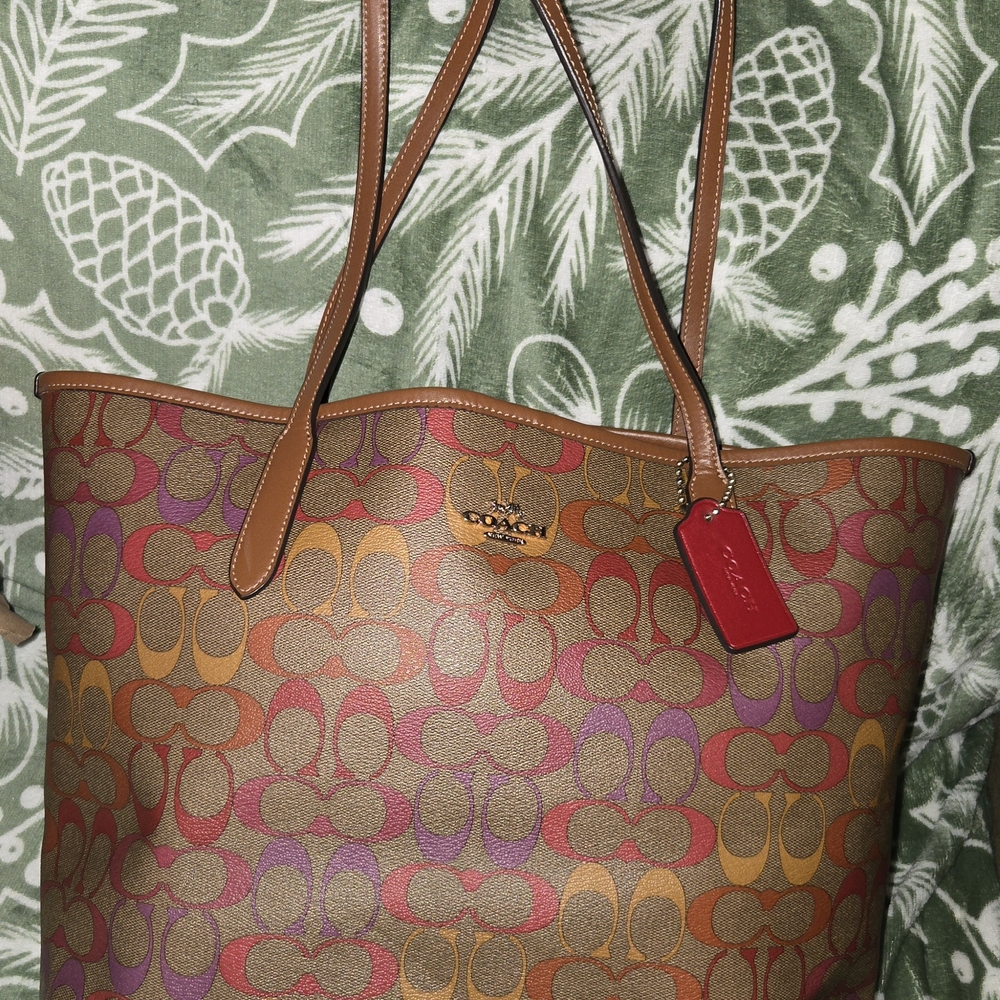COACH SIGNATURE C CITY TOTE IN PINK, ORANGE, AND PURPLE WITH BROWN BACKGROUND